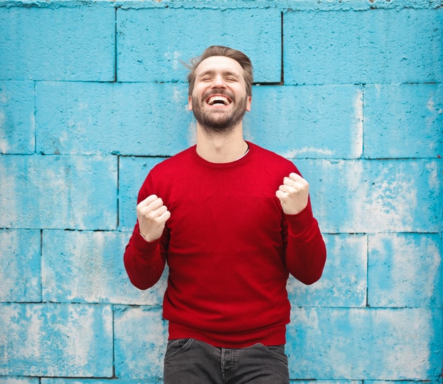 Happy man excitedly learns there are no more flight change fees